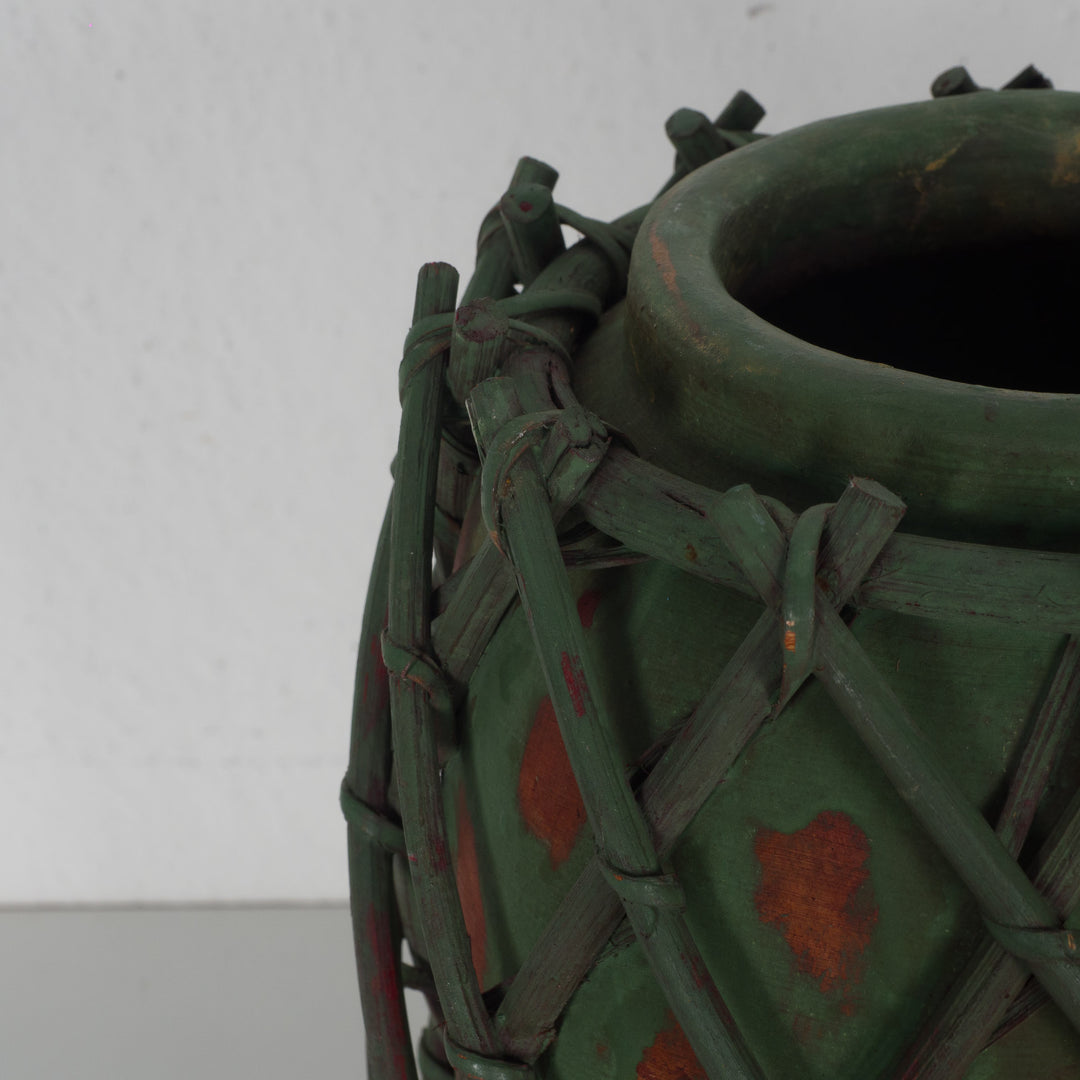 Authentic terracotta vase with wooden wickerwork