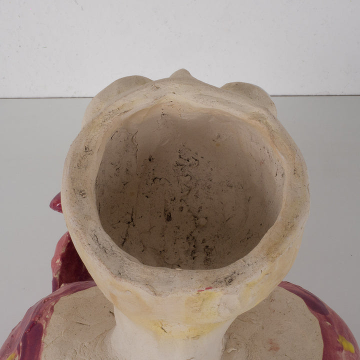 Playful ceramic statue of a busty woman with thick lips.
