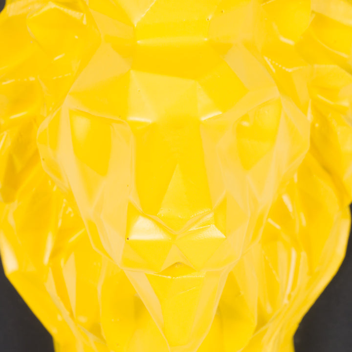 Artwork of a lion head in yellow in resin