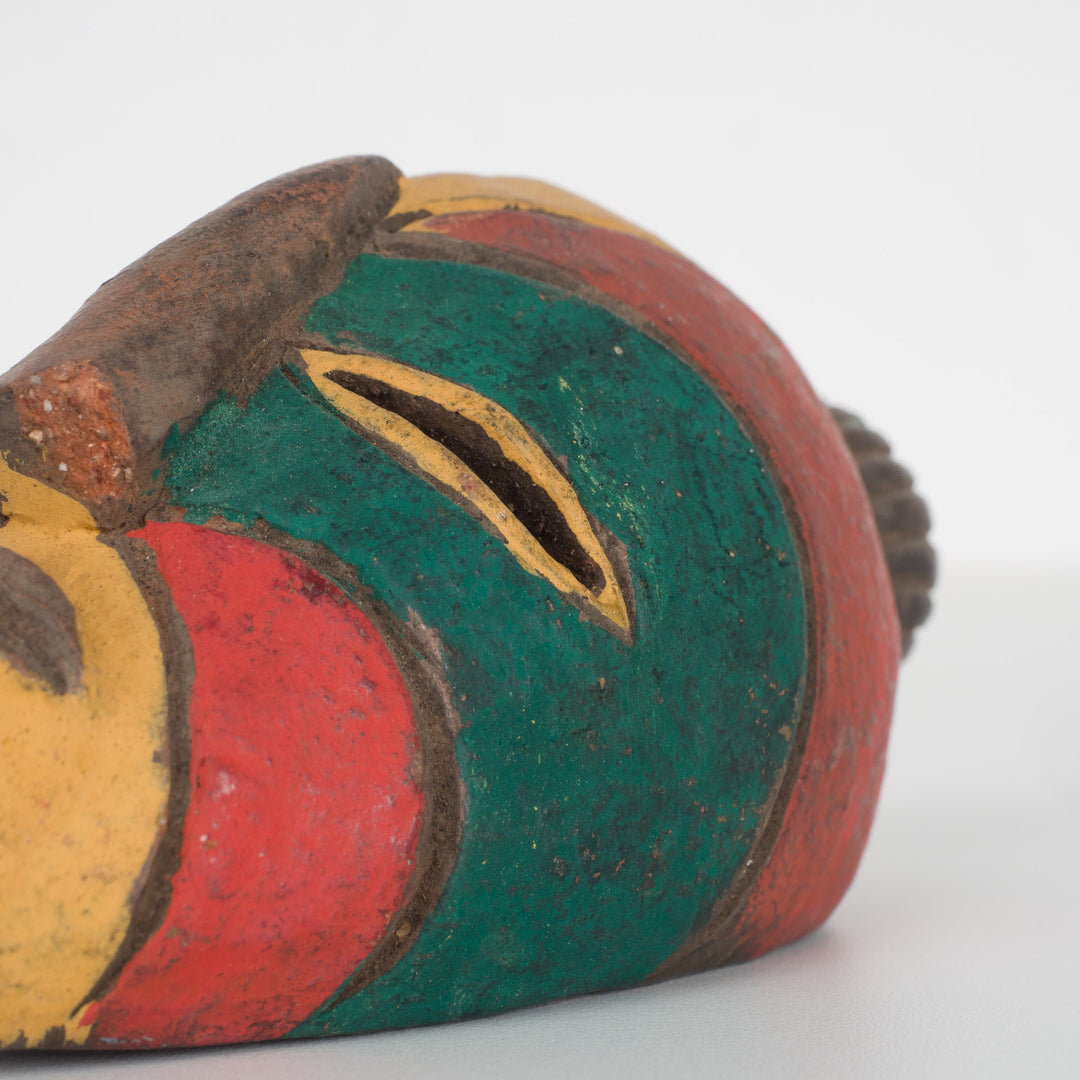 Small African decorative mask – green, red and yellow