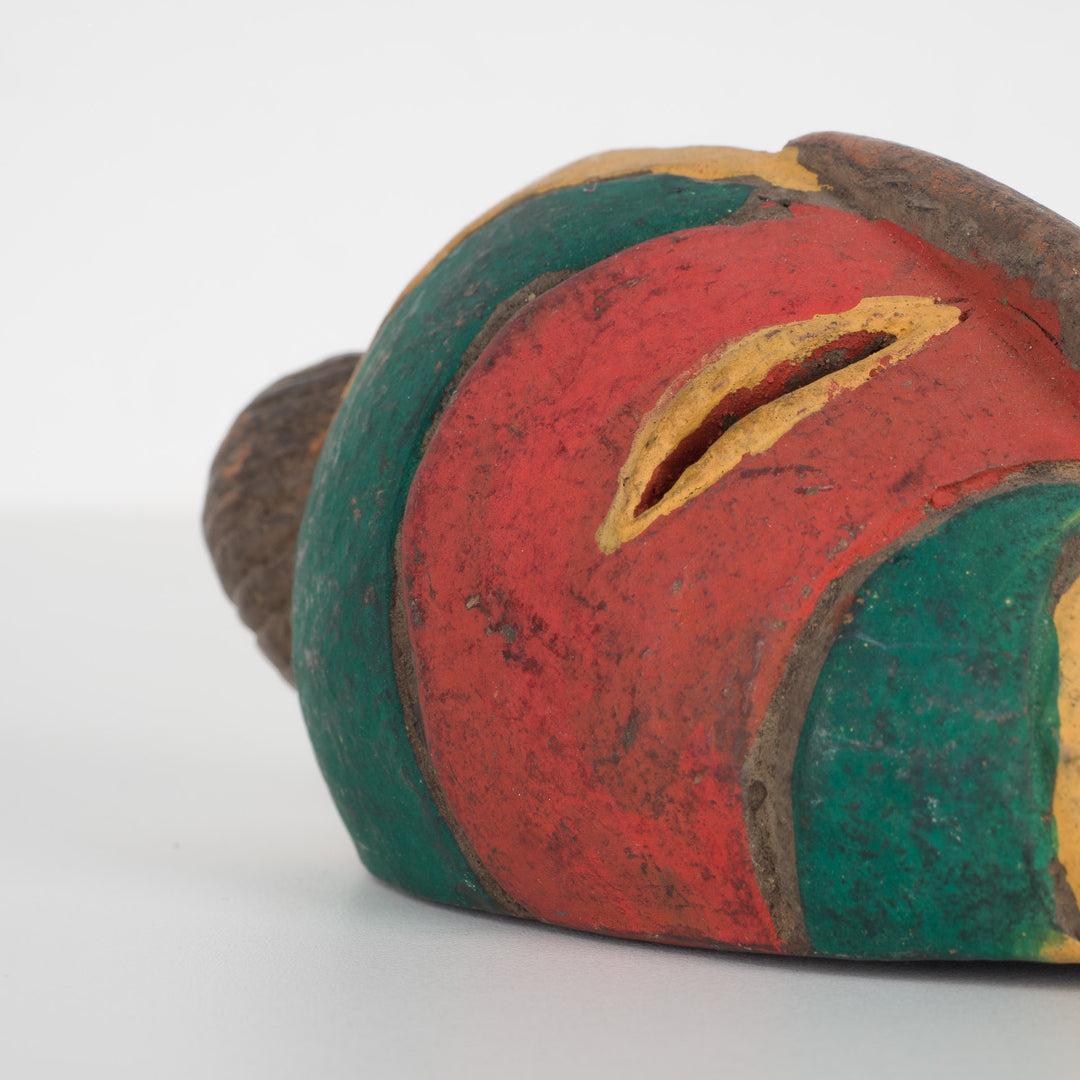 Small African decorative mask – green, red and yellow