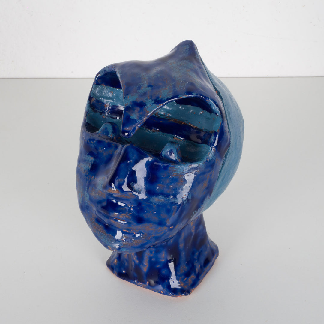 Ceramic face in blue glaze