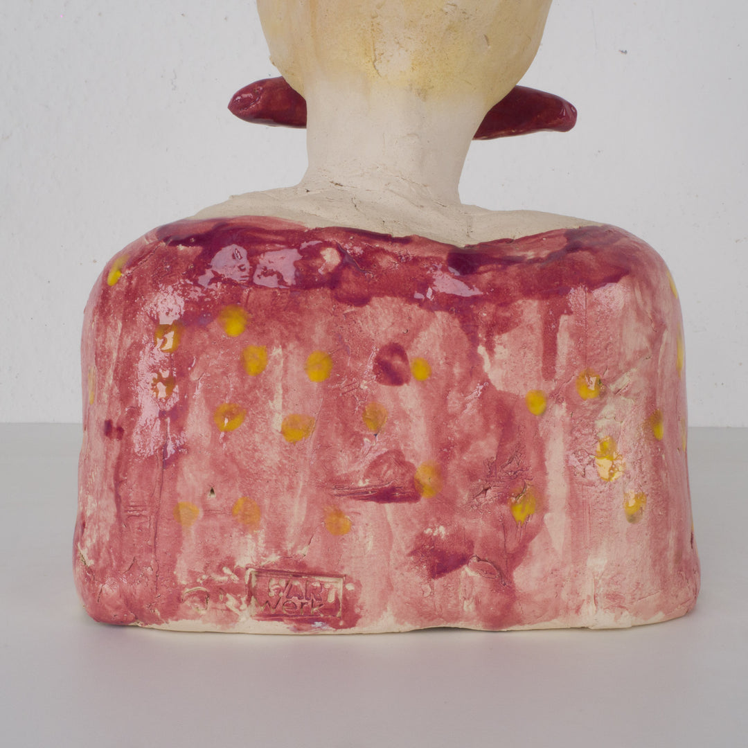 Playful ceramic statue of a busty woman with thick lips.