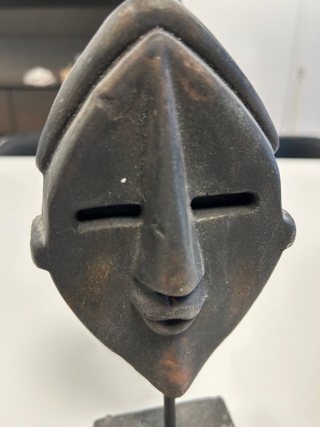 Dark Brown Angular Mask in Stone on Plinth – Mystical Elegance