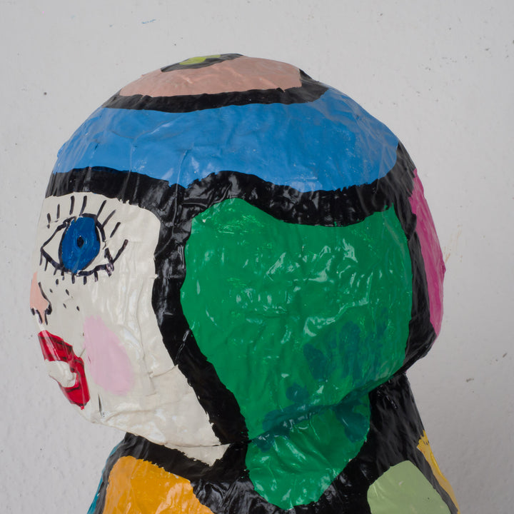 Large colorful statue of a doll in papier mache