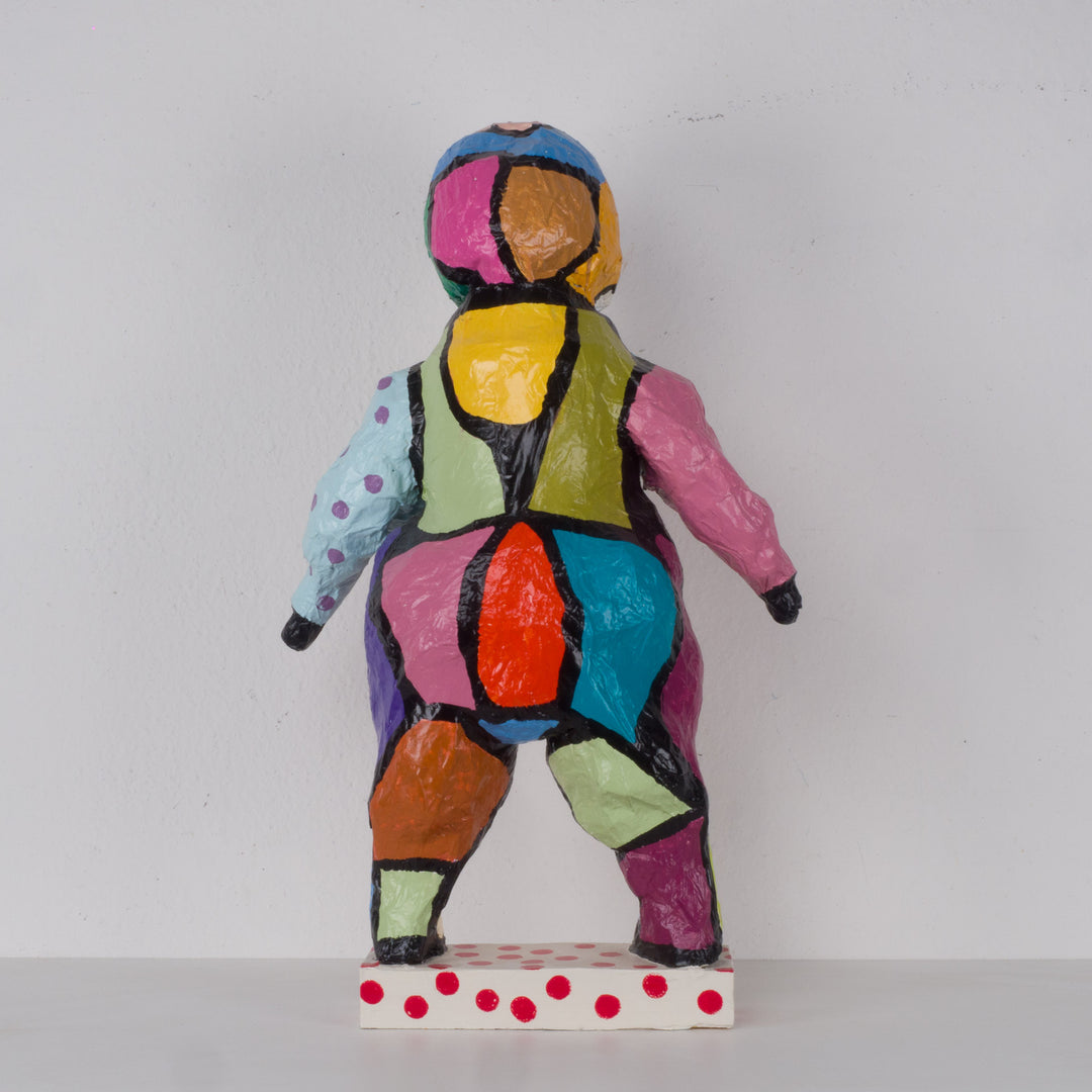 Large colorful statue of a doll in papier mache