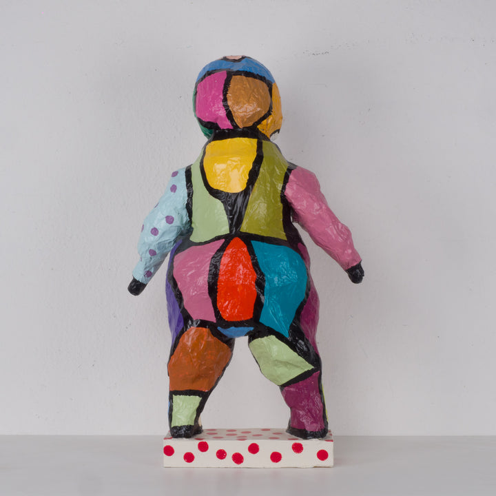 Large colorful statue of a doll in papier mache