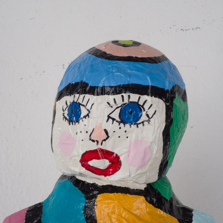 Large colorful statue of a doll in papier mache