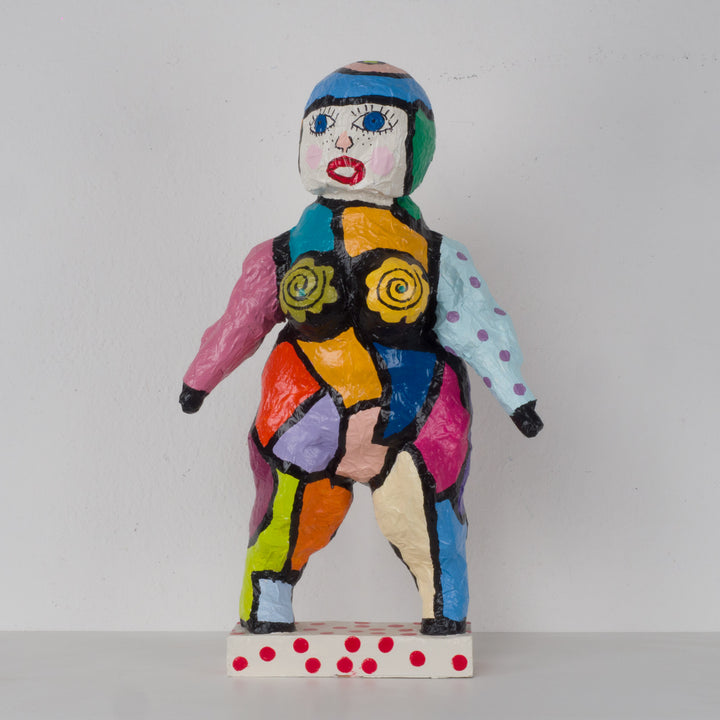 Large colorful statue of a doll in papier mache