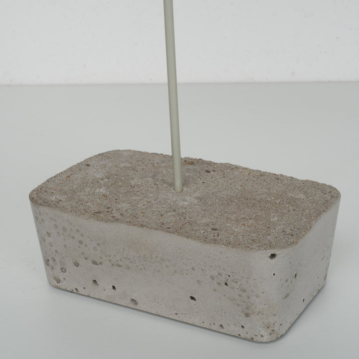Bird in paper mache on concrete base