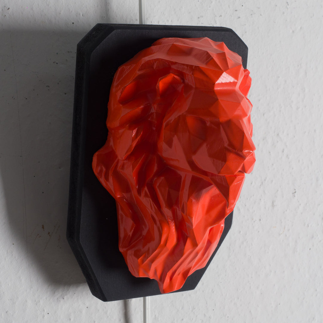 Artwork of a lion head in orange in resin