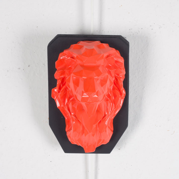 Artwork of a lion head in orange in resin