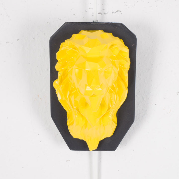 Artwork of a lion head in yellow in resin