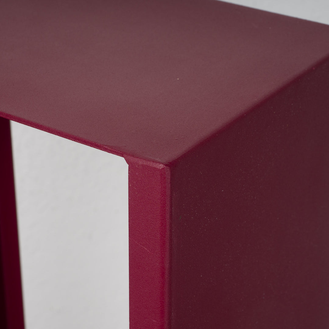 Elongated hollow metal base in burgundy red