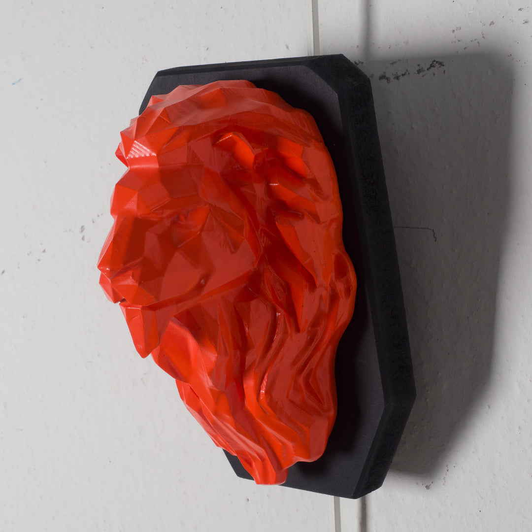 Artwork of a lion head in orange in resin