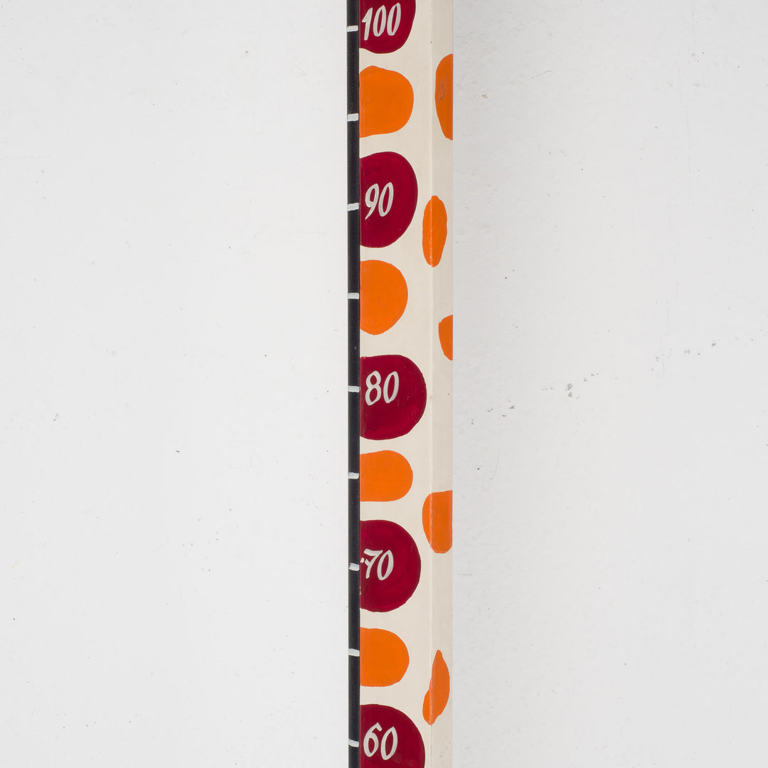 Fun wooden stool with a measuring stick in orange