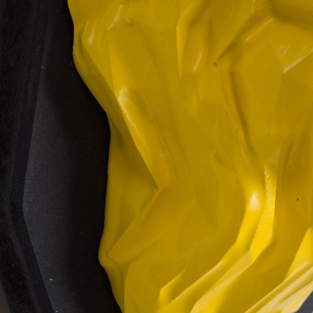 Artwork of a lion head in yellow in resin