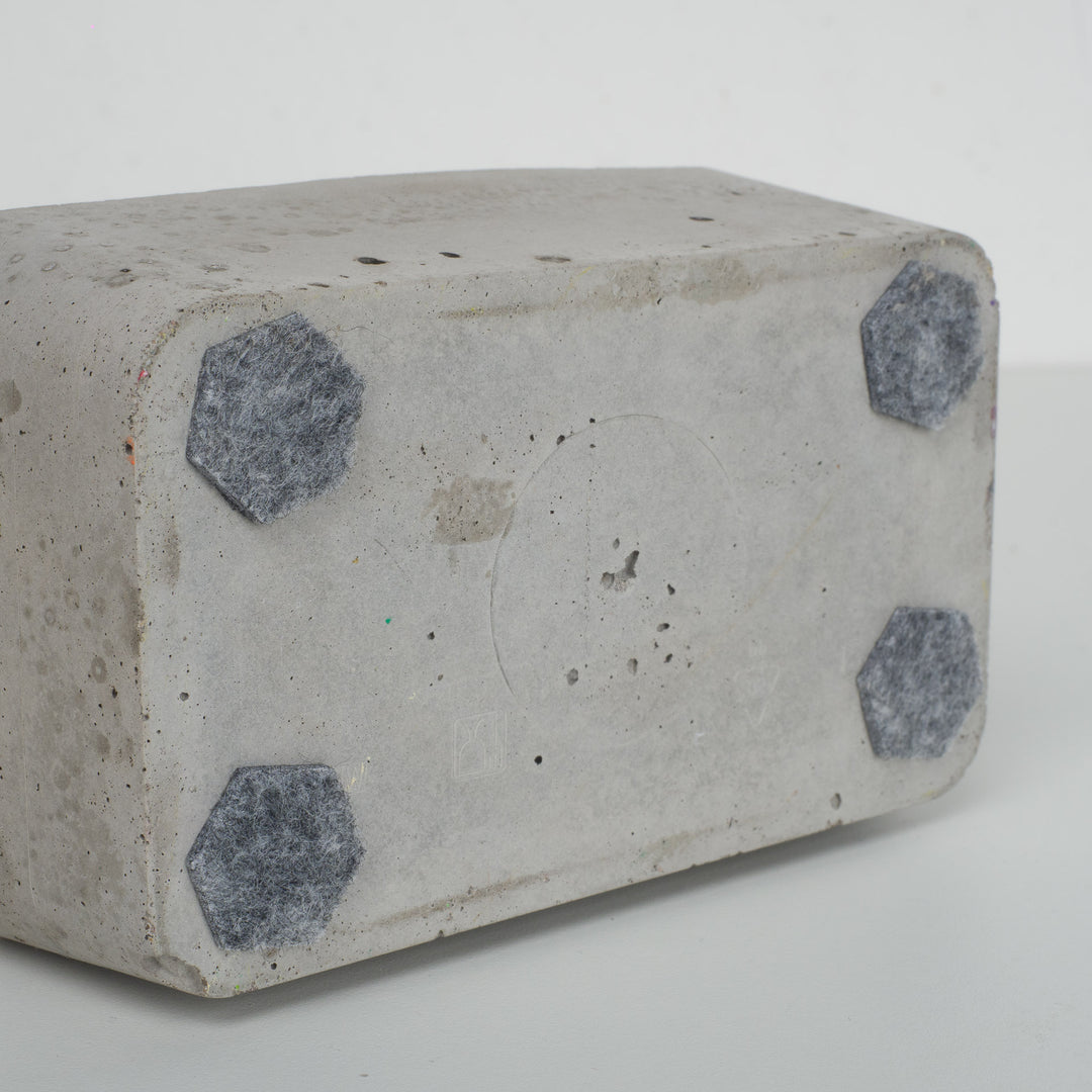 Bird in paper mache on concrete base