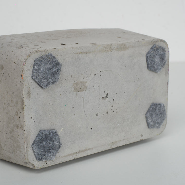 Bird in paper mache on concrete base