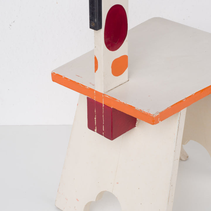 Fun wooden stool with a measuring stick in orange