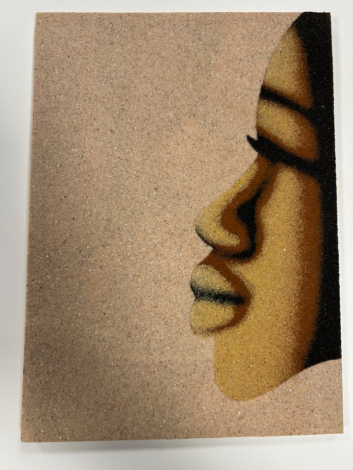 Painting on sand – Woman's face in profile – Senegal