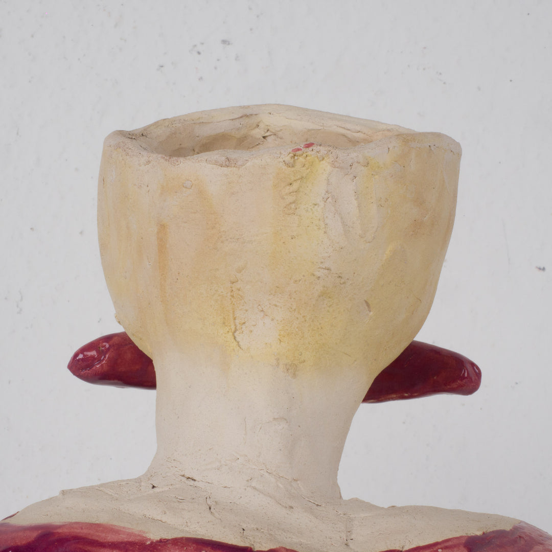 Playful ceramic statue of a busty woman with thick lips.