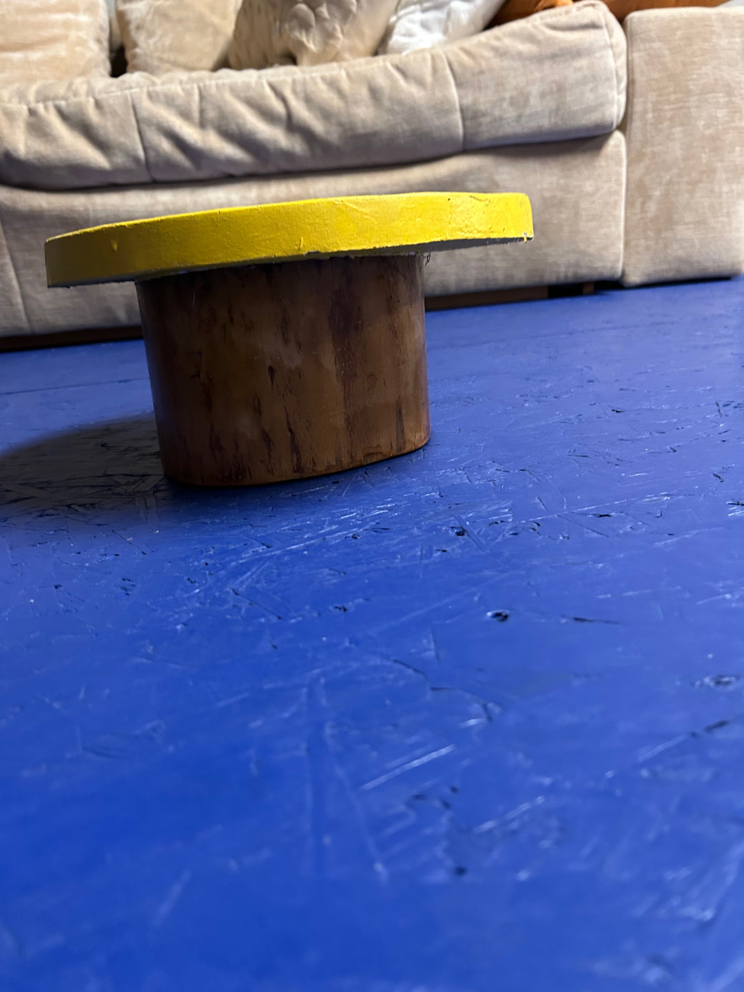 Wooden object with tray in sun in neon yellow