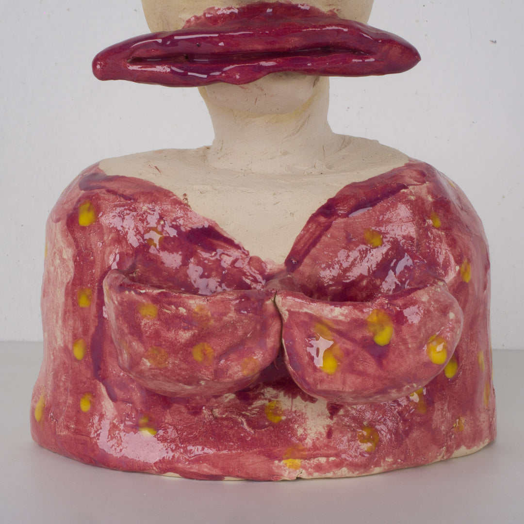 Playful ceramic statue of a busty woman with thick lips.
