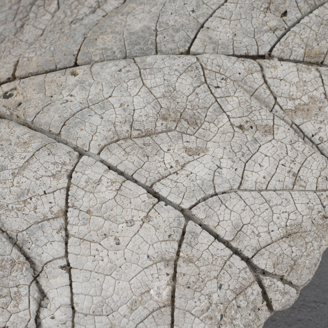 Large and heavy concrete work of art in the shape of a leaf. 