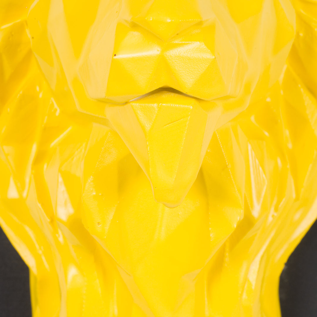 Artwork of a lion head in yellow in resin